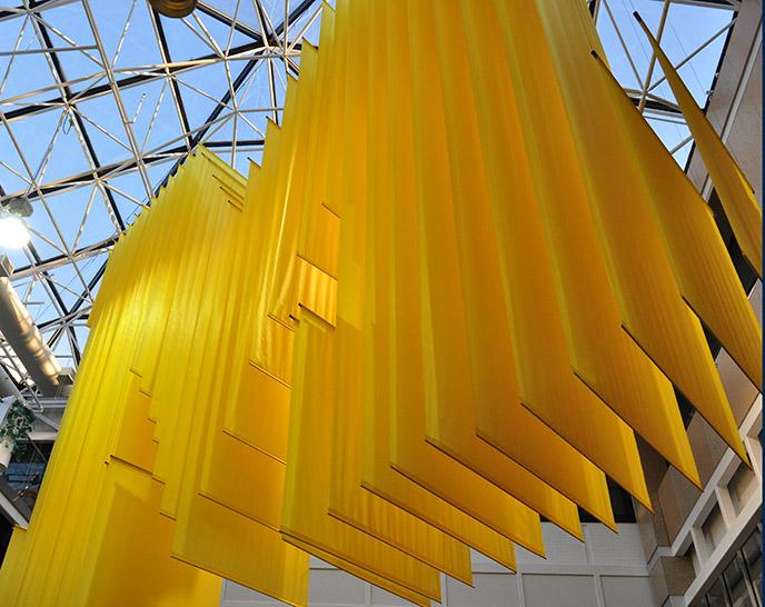 A large block M made of fabric strips handing in the lobby of the Student Activities Building