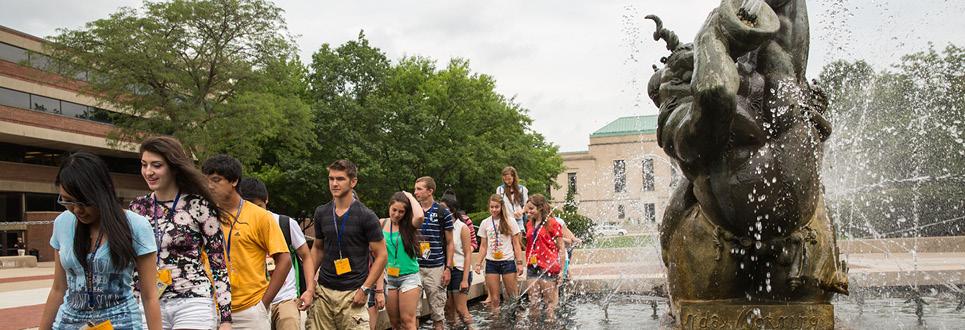 Students walking in fountain during orientation event