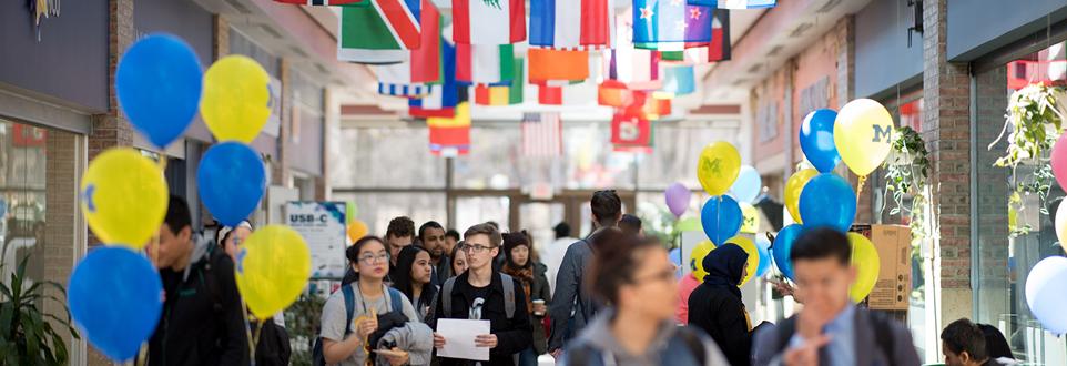 students walking in Pierpont Commons hallway