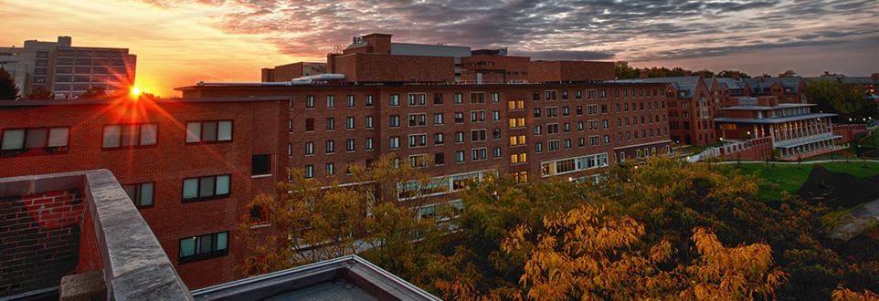 Sunrise coming up from behind Alice Lloyd building