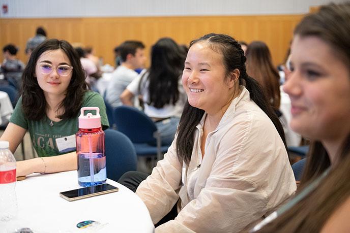 Students sitting around a table at a mentorship event