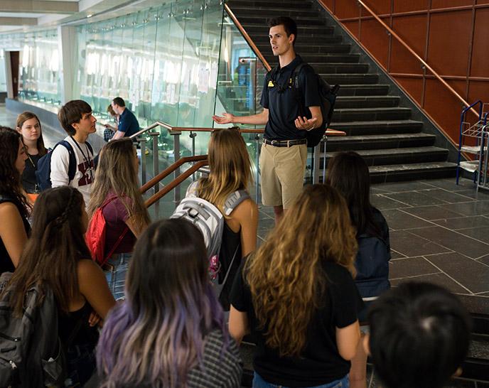A student leading a group of students in a campus tour