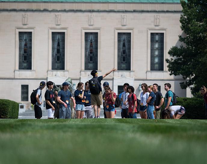 Students on a campus tour in front of the Rackham Building