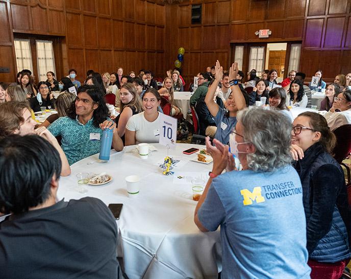 Students at tables at a large Transfer Connections event